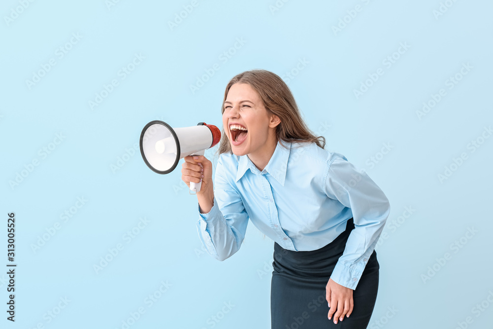 Young businesswoman with megaphone on color background Young businesswoman with megaphone on color background