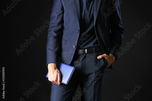 Man in stylish blue clothes on dark background