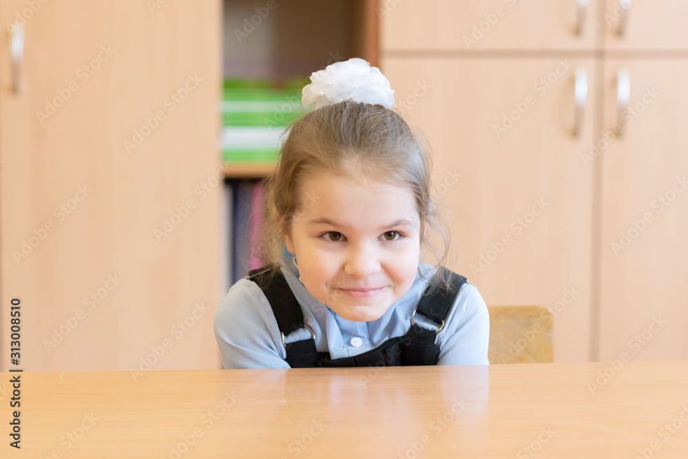 Girl schoolgirl is trying to hide under the desk. Girl schoolgirl is trying to hide under the desk.