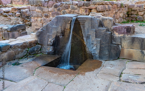 A fountain ruins carved in stone  called the bath of the princess, Ollantaytambo Archaeological Park, Peru photo