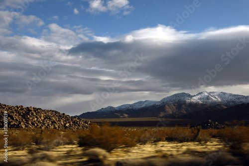 Dramatic clouds over snowy Eagle Mountains in Joshua Tree National Park  California  USA