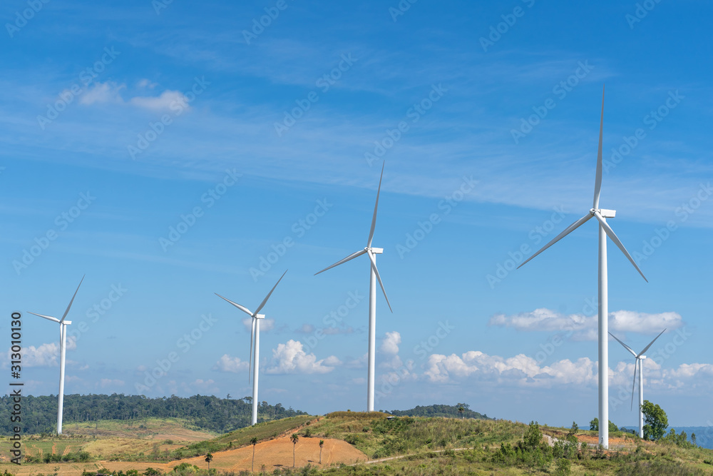 Wind turbines generating electricity with blue sky.
