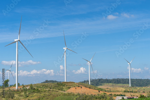 Wind turbines generating electricity with blue sky.