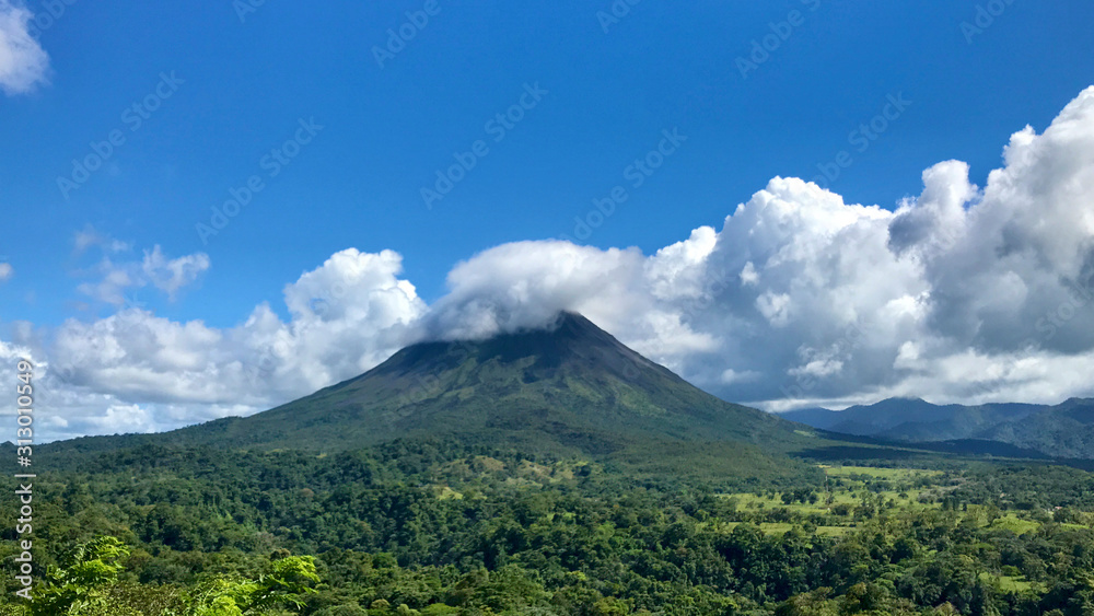Fototapeta premium Arenal Volcano With Clouds Blue Sky Sunset