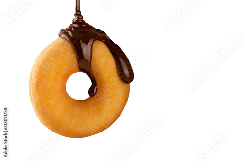Hot melted chocolate falling fluidly on a delicious donut isolated on white background. Creative pastry. Concept of delicious and fast desserts.
