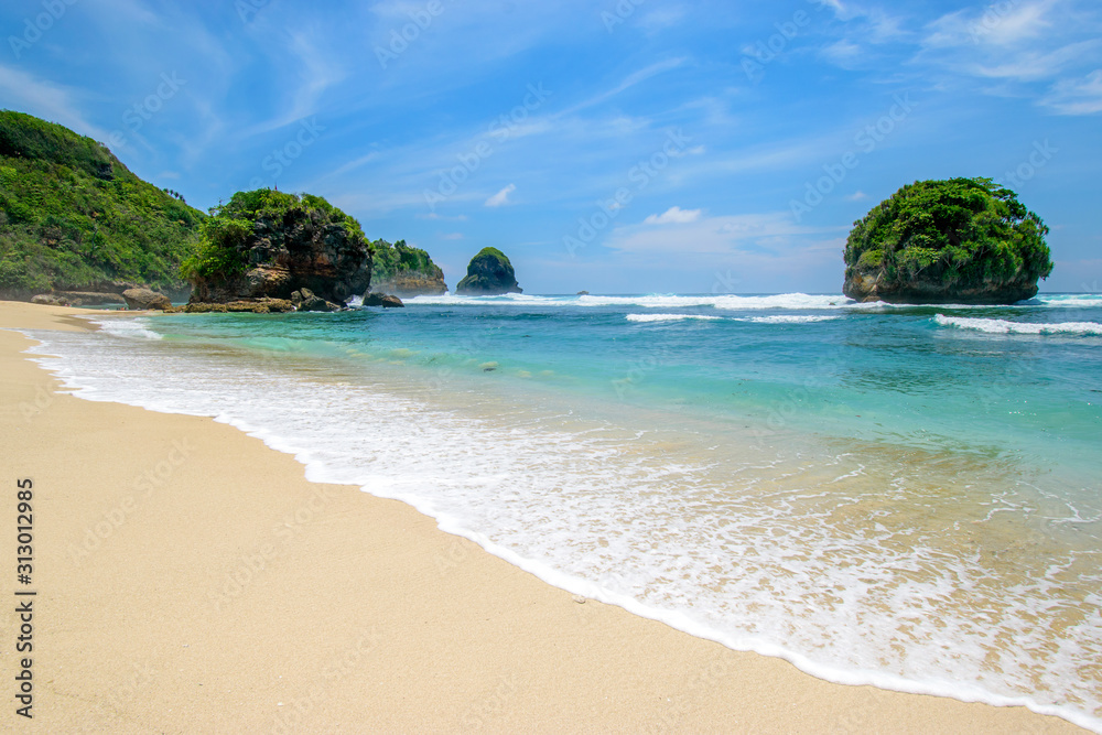 Batu Leter tropical beach with white sand and blue sea in East Java, Indonesia