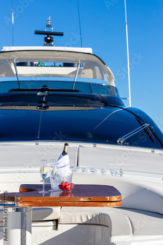 Vertical shot of champagne on the table on the yacht © SPIX PRODUCTION
