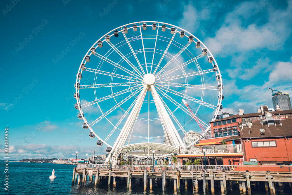Seattle Famous Ferris Wheel in the Harbor Clouds in Sky Blue