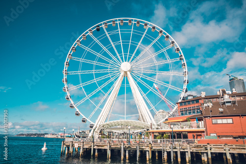 Seattle Famous Ferris Wheel in the Harbor Clouds in Sky Blue