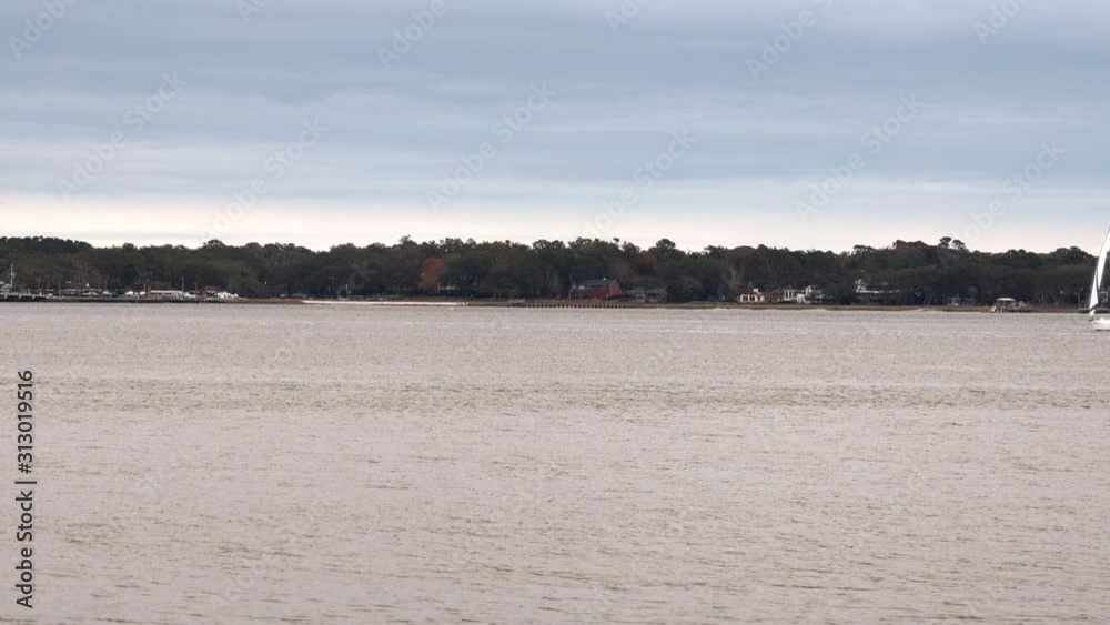 Sail boat sailing across water Sail boat sailing across water