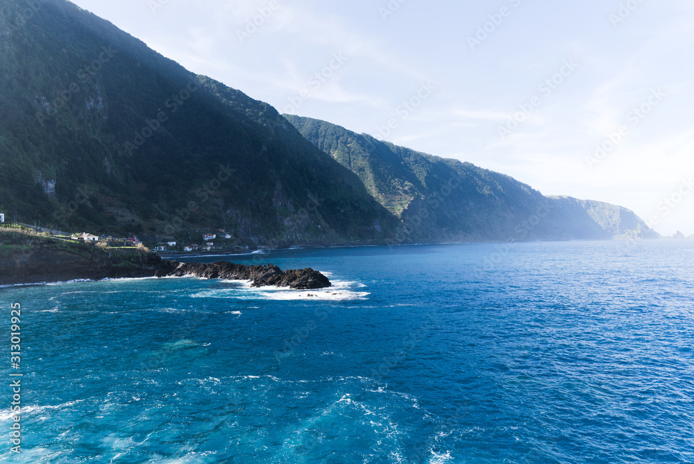 View of beautiful mountains and wild cold ocean on northern coast Madeira island, Portugal
