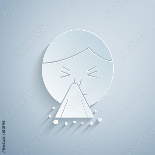 Paper cut Man holding handkerchief or napkin to his runny nose icon isolated on grey background. Coryza desease symptoms. Paper art style. Vector Illustration