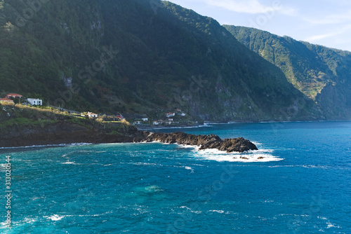 View of beautiful mountains and wild cold ocean on northern coast Madeira island, Portugal photo