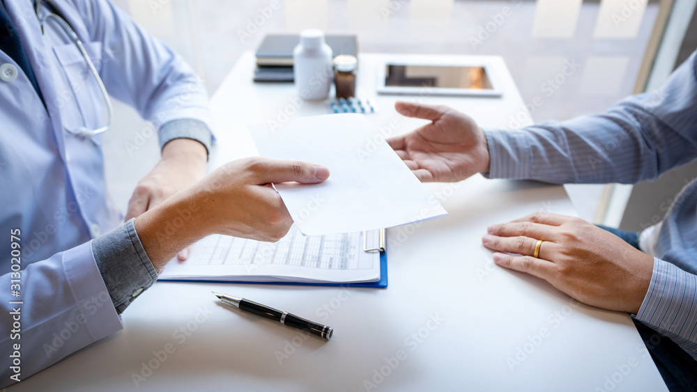 Doctor explaining and giving a consultation to a patient medical informations and diagnosis about the treatment for condition in hospital, medical ethics concept. Doctor explaining and giving a consultation to a patient medical informations and diagnosis about the treatment for condition in hospital, medical ethics concept.