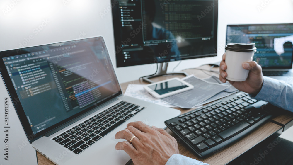Programmer Typing Code on desktop computer, Developing programming and coding technologies concept. Programmer Typing Code on desktop computer, Developing programming and coding technologies concept.