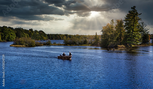 Fototapeta Naklejka Na Ścianę i Meble -  Fishermen in fishing boat on lake in Michigan 