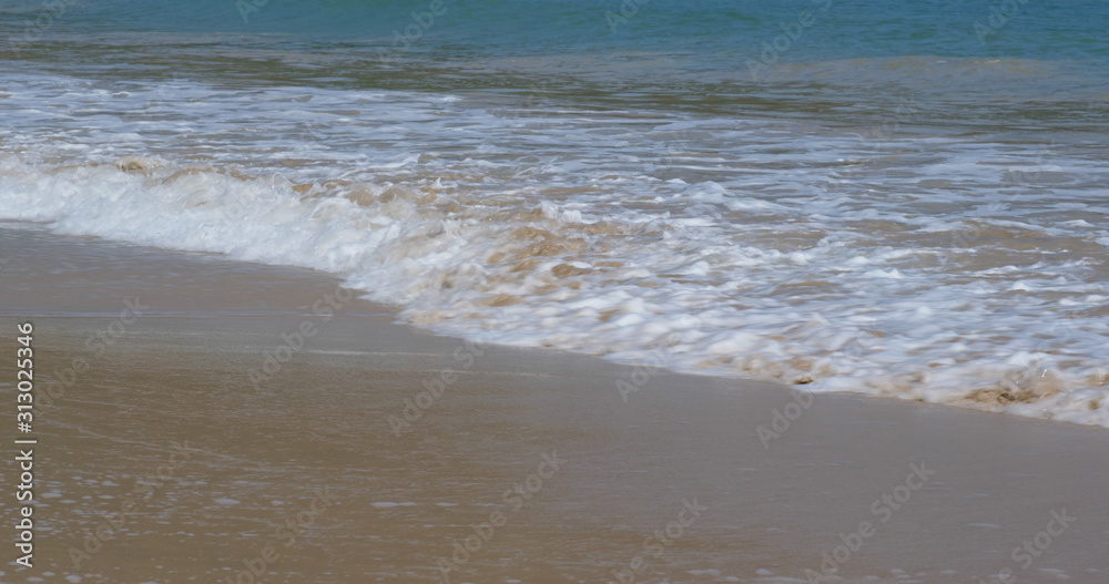 Sandy beach sea wave at ocean