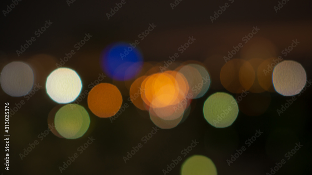 Fototapeta premium Bokeh image of blurred lighting, circle shape of shiny lights from the city in dark night