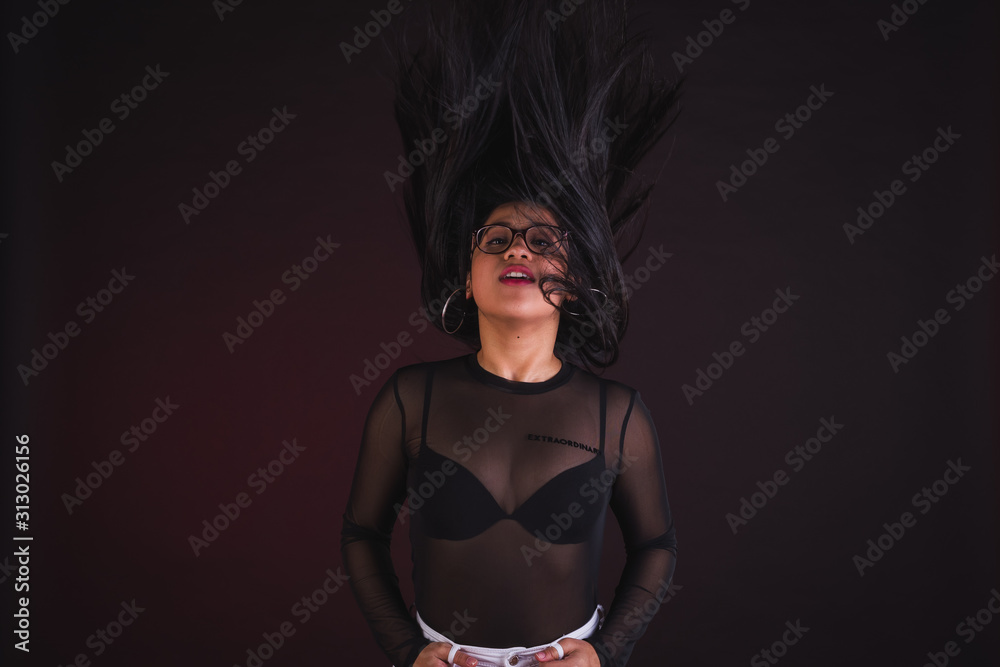 Obraz premium Young girl model posing in black background studio with black transparency t-shirt