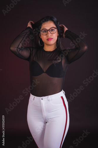 Canvastavla Young girl model posing in black background studio with black transparency t-shi