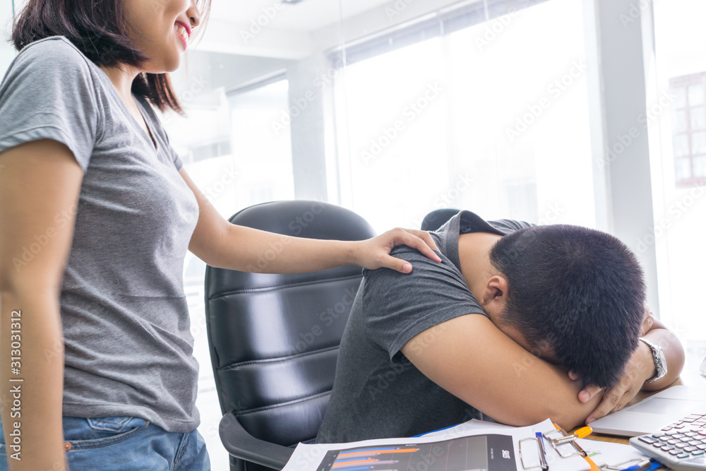 Female waking up her colleague in the office Female waking up her colleague in the office
