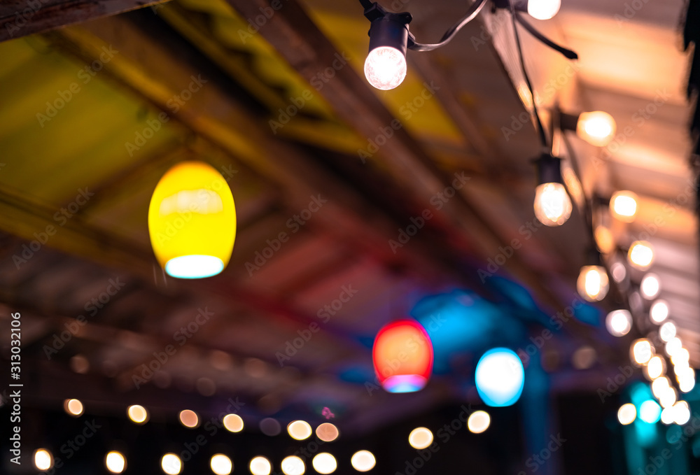 Colorful lights hanging in the roof at night time. decoration concept. selective focus. Colorful lights hanging in the roof at night time. decoration concept. selective focus.