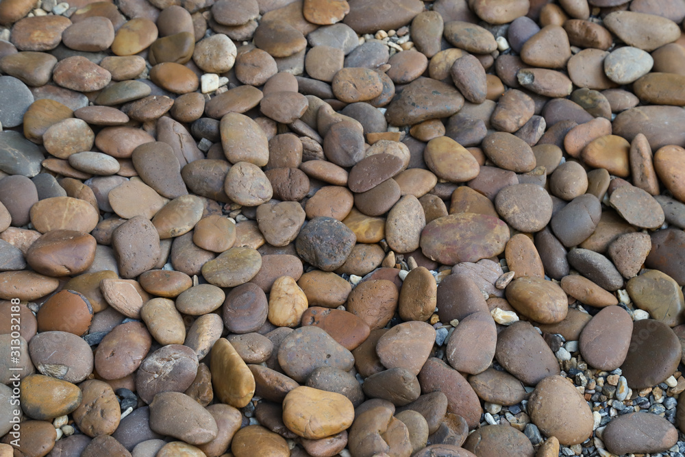 A lot of pebbles on the ground in the garden. Natural art background and template. 