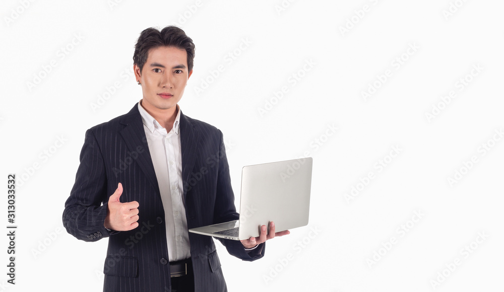 Portrait of Asian handsome businessman wearing a black suit, smiling at the camera with a gray laptop in his hand on a white background and copy space Portrait of Asian handsome businessman wearing a black suit, smiling at the camera with a gray laptop in his hand on a white background and copy space