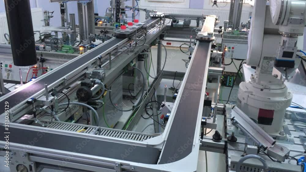 Close-up of automated car which is looping on production line from loading station to unloading station in smart factory. Industry 4.0 smart factory concept; artificial intelligence in production.