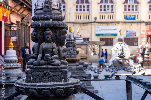 Buddhist shrine surrounded by local houses in the narrow alley of Kathmandu city.