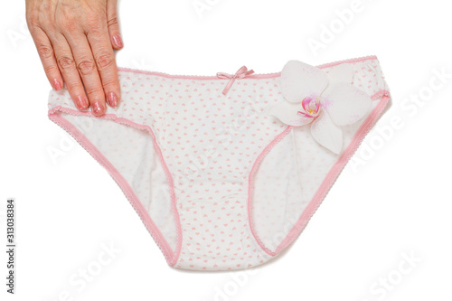 Woman's hand with beautiful panties on white isolated background.