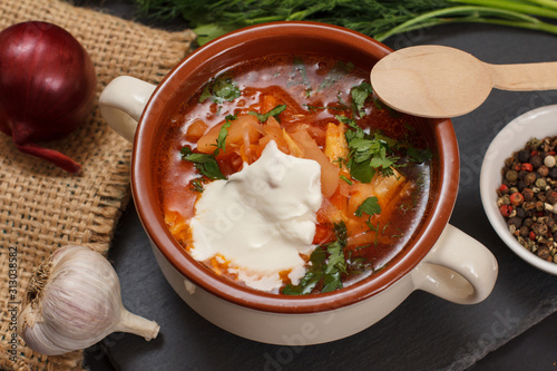 Ukrainian traditional borsch with sour cream and spices.