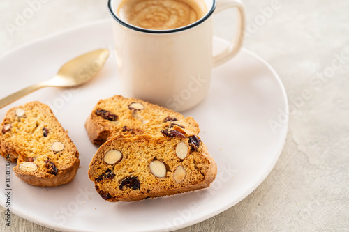 Italian biscotti cookies with a cup of coffee on a light background.