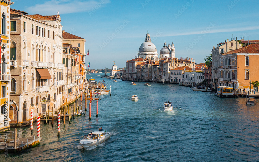 Nice view of grand canal and the classical building in venetian styles from Accademia bridge during evening in Venice , Italy