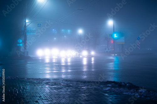 the foogy weather in the city on highway, nobody late in the night photo