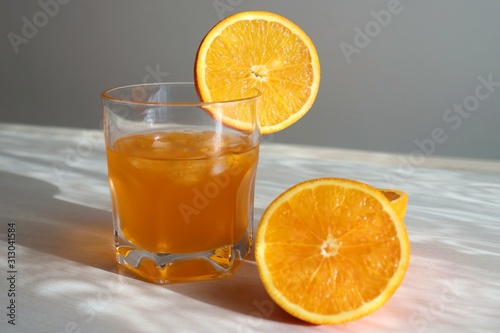 Orange fresh drink, glass of orange juice and ripe citrus fruits on white background