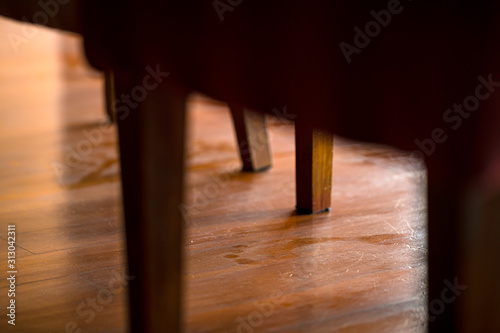 A spoor on muddy dust wooden floor under the table in the house