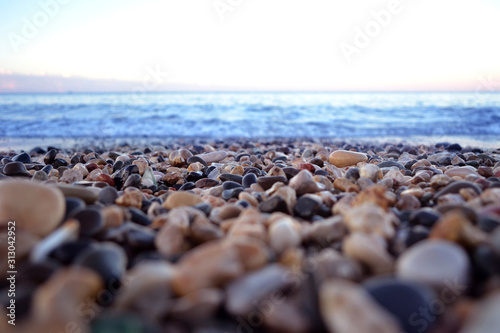 the sea coast in the afternoon with waves and splashes, the sea coast with stones.