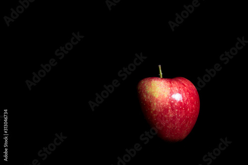 Ripe red apple on black background photo