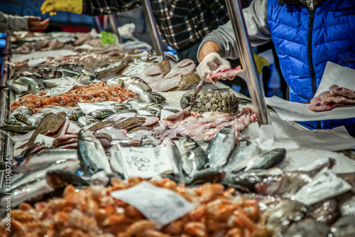 Venetian fish market. The Rialto fish market is located alongside the Grand Canal near the Rialto Bridge - Venice, Italy photo