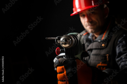 Male worker with an electric dril photo