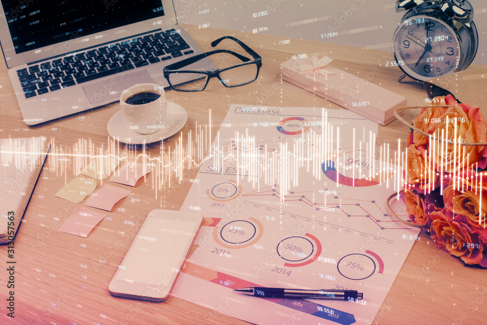Stock market graph on background with desk and personal computer. Multi exposure. Concept of financial analysis.