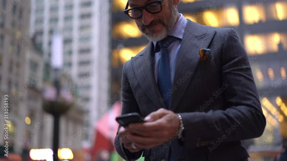 Happy mature man in optical eyewear enjoying online communication with