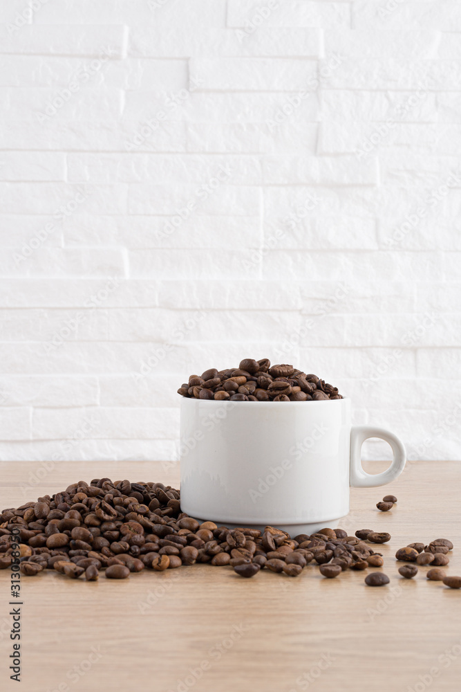 cup of coffee with coffee seeds on wooden table and light brick background cup of coffee with coffee seeds on wooden table and light brick background