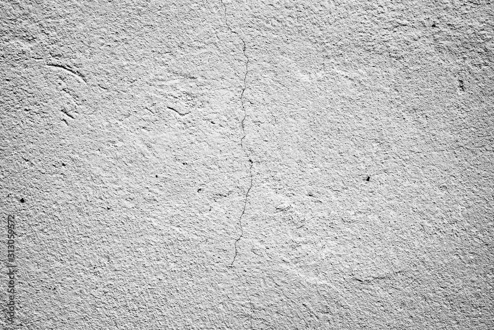 Texture of a concrete wall with cracks and scratches which can be used as a background Texture of a concrete wall with cracks and scratches which can be used as a background