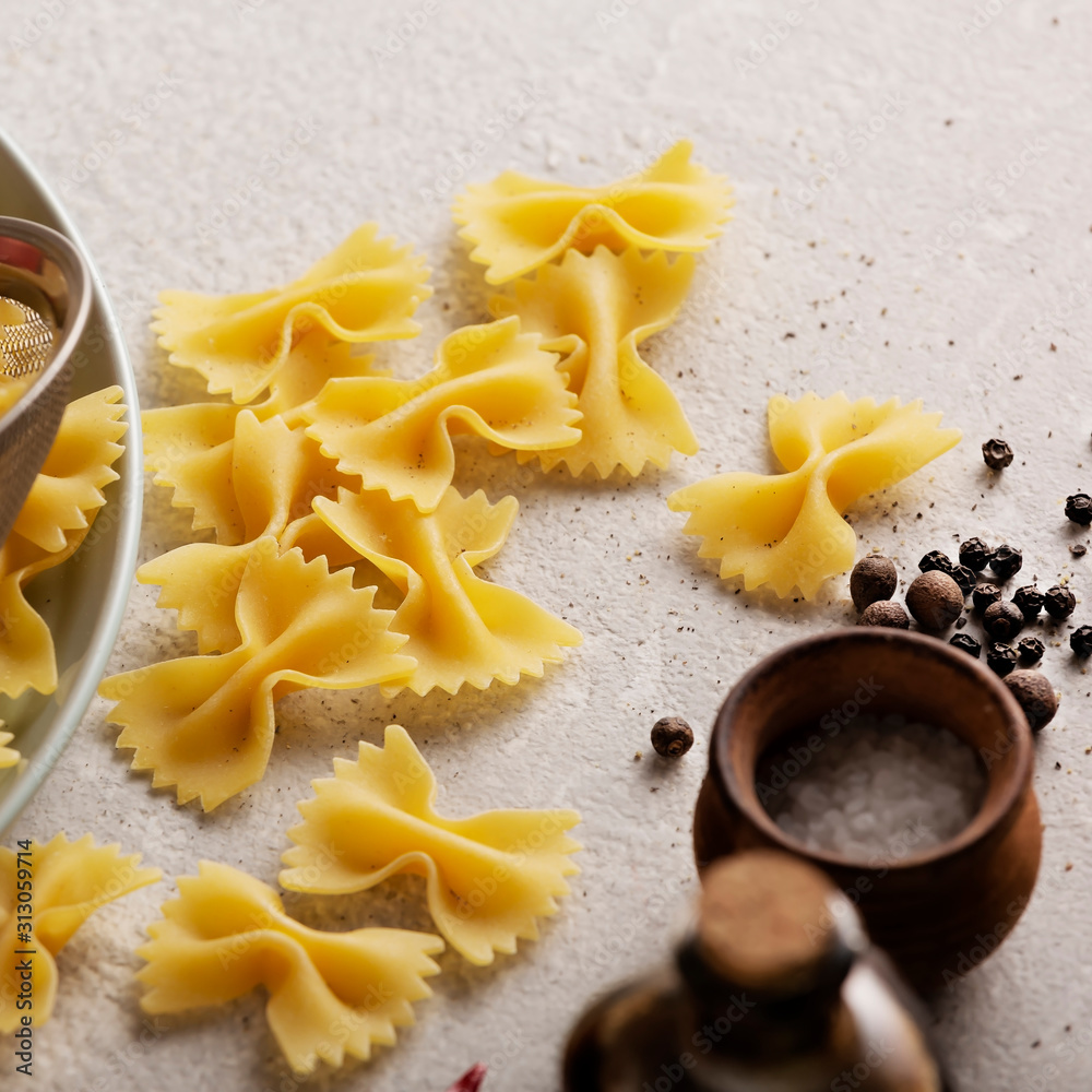 Raw farfalle pasta, vegetables and spices. Italian cooking