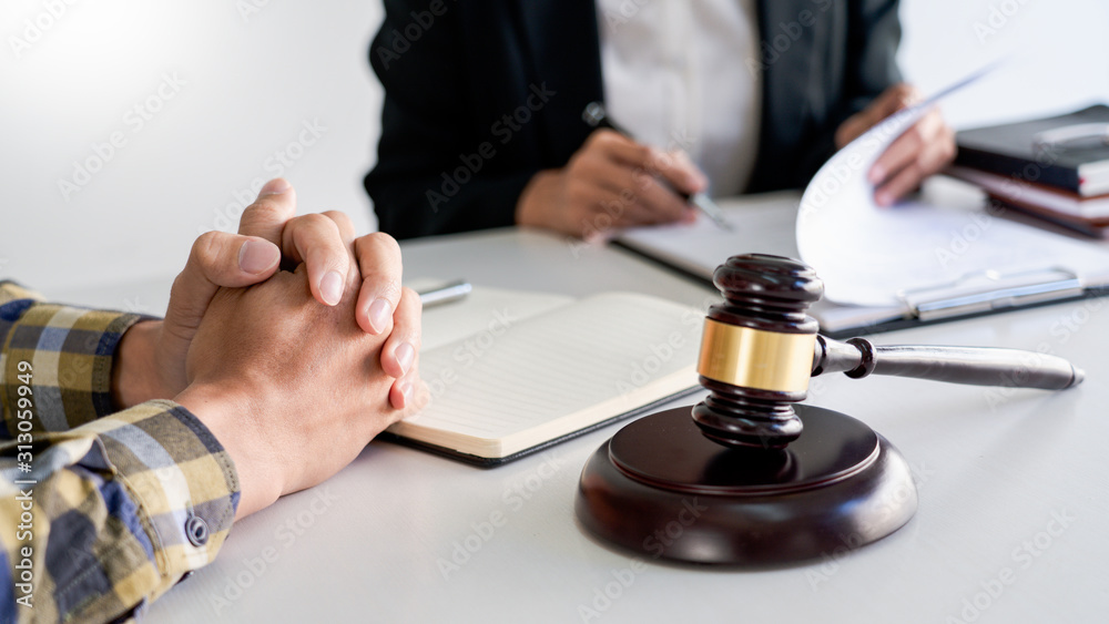 lawyer having meeting and consoling solution to his clients provide legal advice and trust commitment strain serious for problem, justice and attorney concept. lawyer having meeting and consoling solution to his clients provide legal advice and trust commitment strain serious for problem, justice and attorney concept.