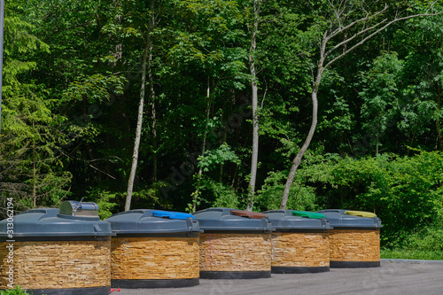 The buried container is designed for the collection and temporary storage of municipal solid waste. Separate waste storage. Aesthetic trash bins yellow, green, brown, blue. © Berg