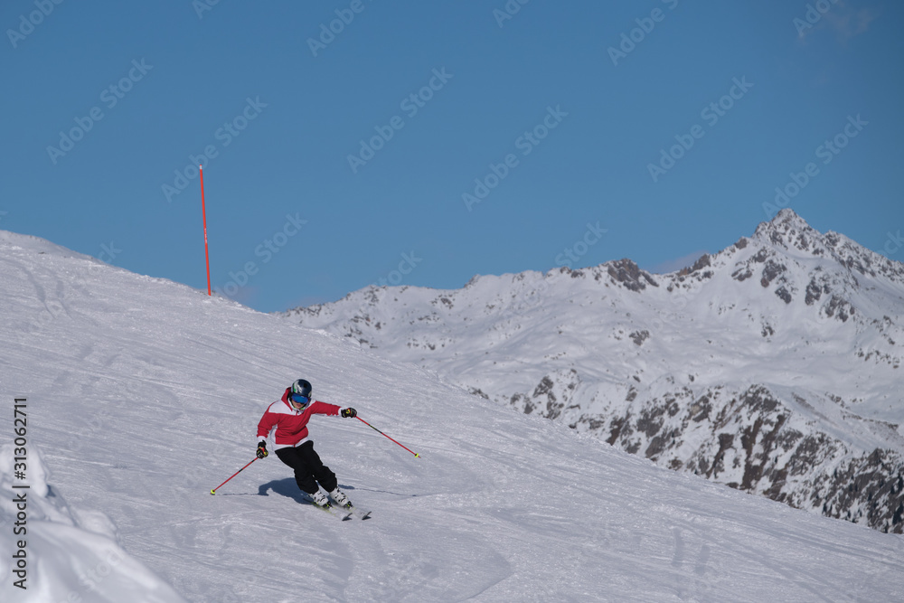 Pinzolo, Italy - декабрь 12, 2019: Young man in a red jacket skiing downhill high speed