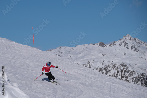 Pinzolo, Italy - декабрь 12, 2019: Young man in a red jacket skiing downhill high speed